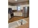 A well-lit kitchen with white cabinets, stainless steel appliances, and wood flooring at 11500 E Cochise Dr # 2067, Scottsdale, AZ 85259