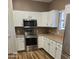 Modern kitchen with stainless steel appliances, white cabinets, and warm countertops at 11500 E Cochise Dr # 2067, Scottsdale, AZ 85259