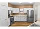 Bright kitchen features stainless steel appliances, white cabinets, and wood-look floors at 11500 E Cochise Dr # 2067, Scottsdale, AZ 85259