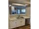 Modern kitchen featuring stainless steel appliances and white cabinets, offering a view to the living room at 11500 E Cochise Dr # 2067, Scottsdale, AZ 85259