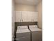 Laundry room with washer, dryer, and white cabinets for storage at 11500 E Cochise Dr # 2067, Scottsdale, AZ 85259