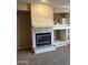 Living room boasts a fireplace with tile surround and built-in shelving at 11500 E Cochise Dr # 2067, Scottsdale, AZ 85259