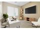 Home office with a white desk, modern decor, and ample natural light from a large window at 11500 E Cochise Dr # 2067, Scottsdale, AZ 85259