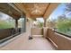 Enclosed patio with ceiling fan and views of greenery and blue skies at 11500 E Cochise Dr # 2067, Scottsdale, AZ 85259