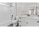 Bathroom with white cabinets, wood-look flooring, and shower-tub combo at 12343 W Essig Way, Peoria, AZ 85383