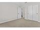 Bedroom featuring carpet, open door to bathroom, and double door closet at 12343 W Essig Way, Peoria, AZ 85383
