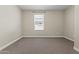 Neutral bedroom with carpet, base trim, window with blinds, electrical outlets, light switch, and fresh paint at 12343 W Essig Way, Peoria, AZ 85383
