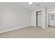 Bedroom with neutral carpet, closet, and view to the ensuite bathroom at 12343 W Essig Way, Peoria, AZ 85383