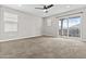 Bedroom with ceiling fan, carpet, and sliding glass doors to patio at 12343 W Essig Way, Peoria, AZ 85383