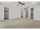 Large bedroom featuring neutral carpet, ceiling fan, and two walk-in closets at 12343 W Essig Way, Peoria, AZ 85383