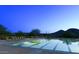 Stunning community lap pool offers a serene nighttime retreat with mountain views at 12343 W Essig Way, Peoria, AZ 85383