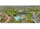 Aerial view of community pool featuring winding pools, splash pads, covered seating areas, and landscaping at 12343 W Essig Way, Peoria, AZ 85383