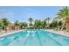 Beautiful lap pool surrounded by trees and lounge chairs provides a resort-like experience for residents at 12343 W Essig Way, Peoria, AZ 85383