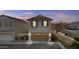 Attached two-car garage with brown garage door, and additional parking space in the driveway at 12343 W Essig Way, Peoria, AZ 85383