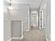 Hallway with carpet and neutral paint, featuring arched doorway and lighting at 12343 W Essig Way, Peoria, AZ 85383