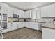 Bright kitchen with white cabinetry, stainless steel appliances, and modern backsplash at 12343 W Essig Way, Peoria, AZ 85383