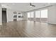 Open-concept living space with wood-look tile flooring, with lots of natural light and neutral walls at 12343 W Essig Way, Peoria, AZ 85383