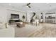 Bright living room featuring wood tile flooring, with archways to the dining room and kitchen at 12343 W Essig Way, Peoria, AZ 85383