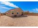 An exterior angle of home in backyard featuring desert landscape, block fencing, and covered patio at 1250 E Eric Pl, Casa Grande, AZ 85122