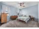 Comfortable bedroom boasting carpeted floors, ceiling fan, and plentiful natural light at 1250 E Eric Pl, Casa Grande, AZ 85122