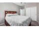 Bright bedroom with neutral colors and a wooden headboard with storage at 1250 E Eric Pl, Casa Grande, AZ 85122