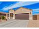 Charming single-story home featuring a two-car garage, neutral stucco, and low maintenance desert landscaping at 1250 E Eric Pl, Casa Grande, AZ 85122
