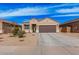 Charming single-story home featuring a two-car garage, neutral stucco, and low maintenance desert landscaping at 1250 E Eric Pl, Casa Grande, AZ 85122