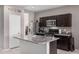 Functional kitchen island complemented by stainless steel appliances and dark wood cabinets at 1250 E Eric Pl, Casa Grande, AZ 85122