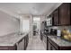 The kitchen features stainless steel appliances, an island, and granite countertops, perfect for cooking at 1250 E Eric Pl, Casa Grande, AZ 85122