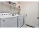 A laundry room featuring a white washer and dryer, a white door, and shelves above at 1250 E Eric Pl, Casa Grande, AZ 85122