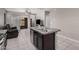 Open concept kitchen-living area with an island, sliding glass doors, and neutral decor at 1250 E Eric Pl, Casa Grande, AZ 85122