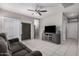 Spacious living room featuring tile flooring, ceiling fan, and sliding glass doors to the outside at 1250 E Eric Pl, Casa Grande, AZ 85122