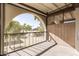 Screened in balcony with a view of palm trees and neighboring property at 131 N Higley Rd # 215, Mesa, AZ 85205