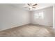 Carpeted bedroom with a ceiling fan, bright window, and neutral walls at 131 N Higley Rd # 215, Mesa, AZ 85205