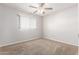 Neutral bedroom with a bright window and a ceiling fan at 131 N Higley Rd # 215, Mesa, AZ 85205