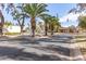 An entrance to the community featuring well-manicured landscaping and an American flag in the background at 131 N Higley Rd # 215, Mesa, AZ 85205