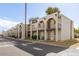 Charming apartment complex featuring a desert color scheme and exterior staircases for upper-level units at 131 N Higley Rd # 215, Mesa, AZ 85205