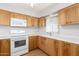 Well-lit kitchen featuring wood cabinetry, modern appliances, and a practical layout for convenient meal preparation at 131 N Higley Rd # 215, Mesa, AZ 85205
