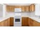 Bright kitchen features wooden cabinets, a white countertop, and modern white appliances at 131 N Higley Rd # 215, Mesa, AZ 85205