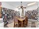 A cozy library room with extensive bookshelves filled with books and a wooden table with chairs at 131 N Higley Rd # 215, Mesa, AZ 85205