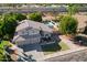 Aerial view of a tan two-story home featuring a pool and manicured lawn at 1320 N Desoto St, Chandler, AZ 85224