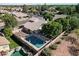 Aerial view of fenced backyard with pool, patio, mature trees, and well-maintained landscaping at 1320 N Desoto St, Chandler, AZ 85224