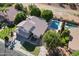 View of house with tile roof, fenced pool and yard with mature trees, and patio area at 1320 N Desoto St, Chandler, AZ 85224