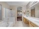 Bright bathroom featuring a soaking tub, walk-in shower, and dual vanities at 1538 N Atwood --, Mesa, AZ 85207