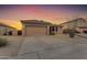 Well-maintained home exterior with a two-car garage and desert landscaping at 1538 N Atwood --, Mesa, AZ 85207