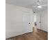 Bright bedroom featuring wood flooring and neutral walls, leading to another room at 1611 E Palmcroft Dr, Tempe, AZ 85282