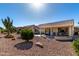 Spacious backyard with desert landscaping, covered patio, and plenty of room to entertain at 16476 W Limestone Dr, Surprise, AZ 85374