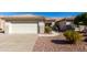 Charming single-story home showcasing low-maintenance landscaping and a two-car garage at 16476 W Limestone Dr, Surprise, AZ 85374