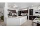 Beautiful kitchen featuring dark wood cabinetry, stainless steel appliances, and granite countertops at 16476 W Limestone Dr, Surprise, AZ 85374