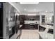 Modern kitchen featuring stainless steel appliances, dark wood cabinetry, and bright lighting at 16476 W Limestone Dr, Surprise, AZ 85374